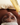 holding skincare product next to client's face with soap on their face