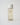 yellow liquid skincare in a clear bottle with a white top