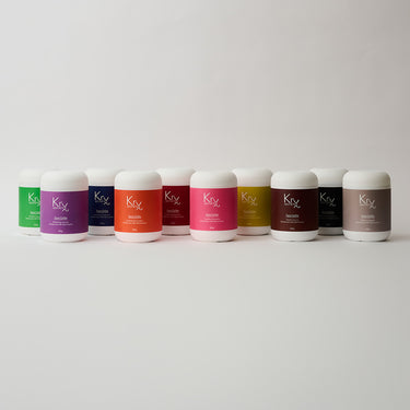 a hand full of face masks in colorful bottles