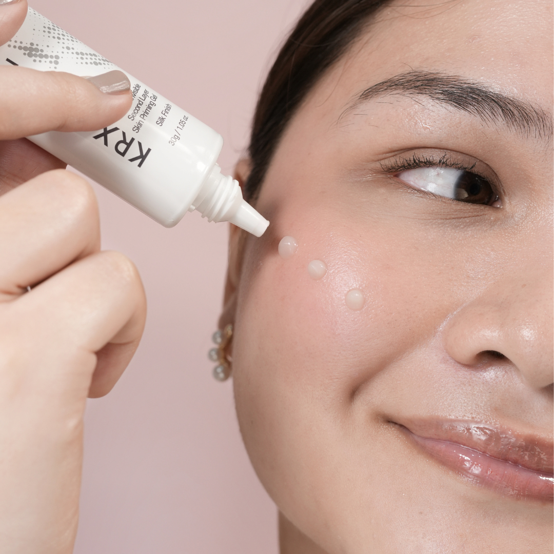 model squeezing makeup primer on face 