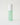 green bottle with facial toner with a white top
